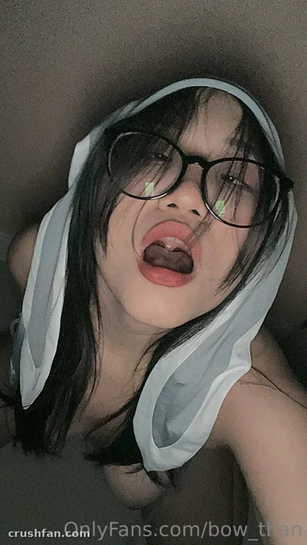 Bow Than in glasses with a light cloth draped over her head in a close selfie.