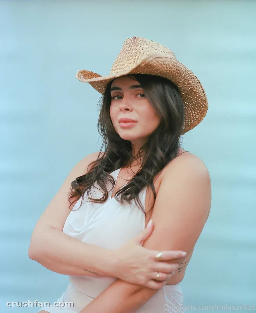 Mila ☆ Baby in a straw hat and white top against a blue background