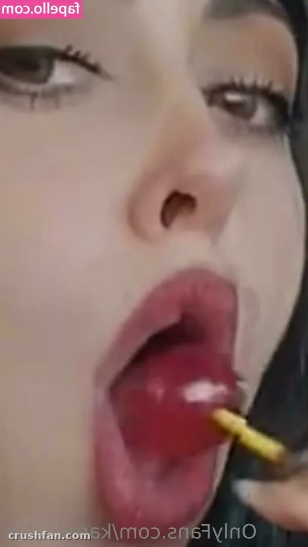 Close-up portrait of Karen Calab with glossy red lips and dark eye makeup.