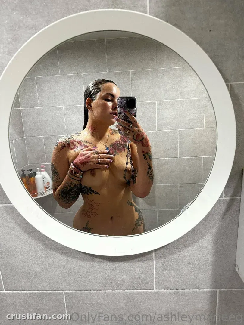 AshleyMarie taking a mirror selfie in a tiled bathroom