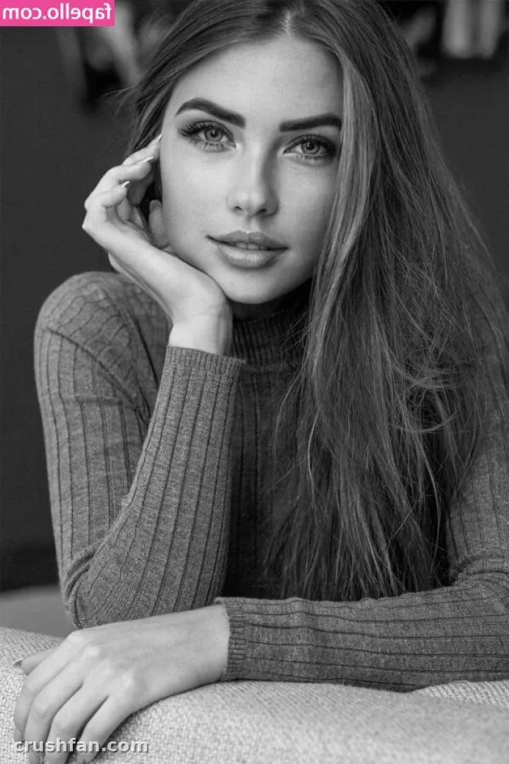 Black and white portrait of Niemira resting her chin on her hand in a ribbed turtleneck
