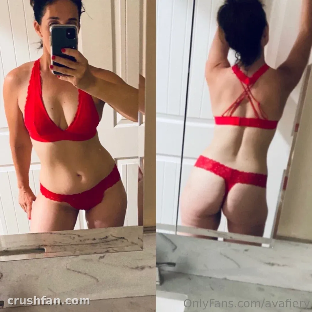 Ava in a red lingerie set taking a mirror selfie in a bathroom