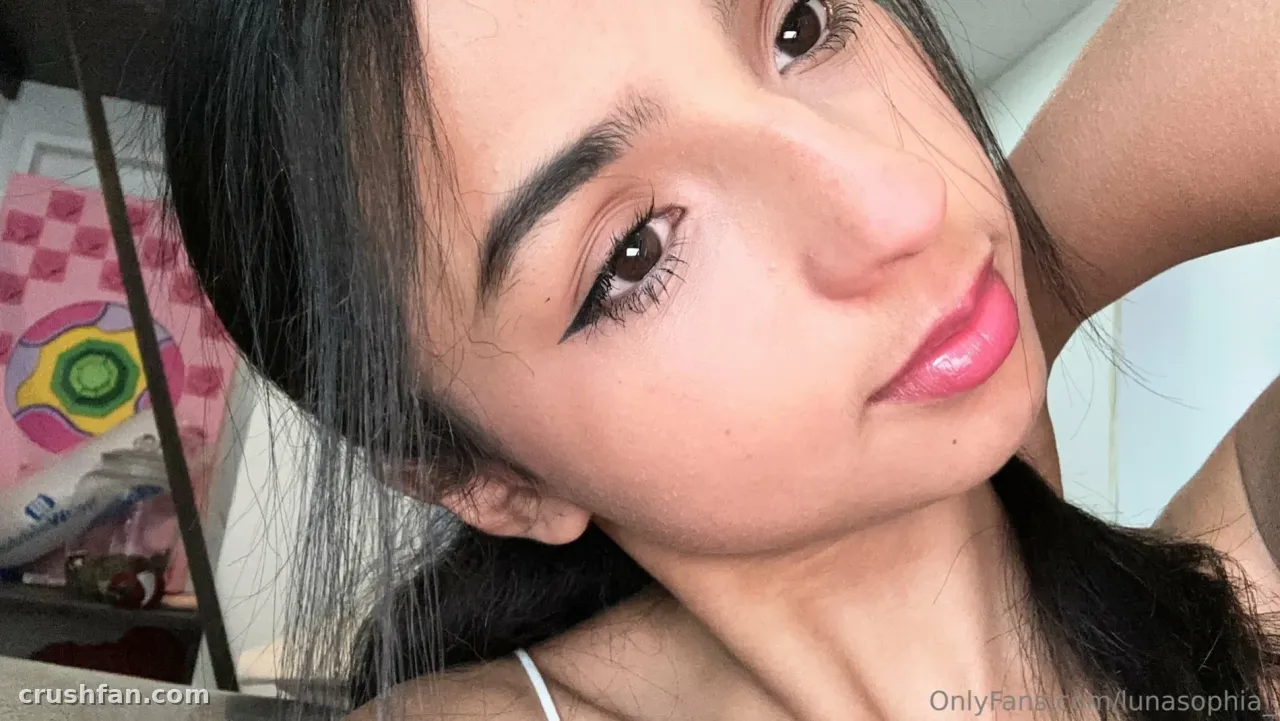 Selfie en gros plan de Luna Sophia avec cheveux foncés et couleur à lèvres rose en intérieur
