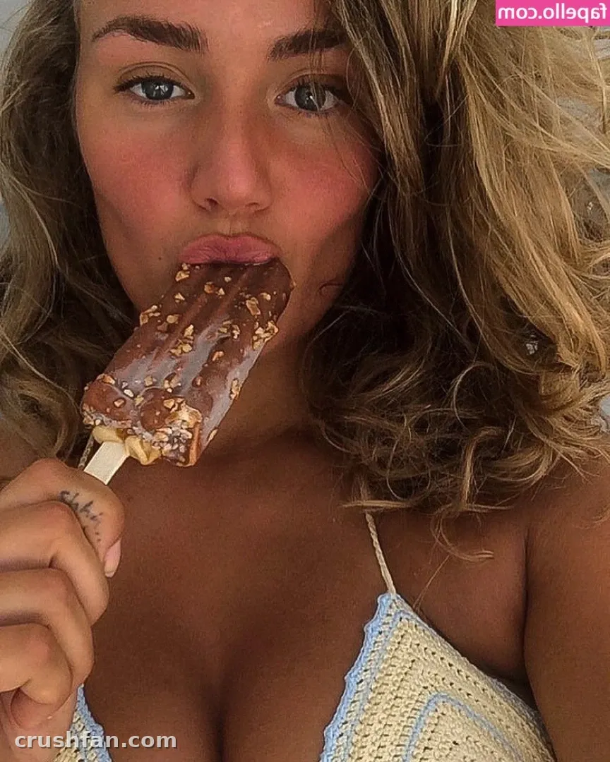 Close-up portrait of a woman holding a chocolate ice cream bar