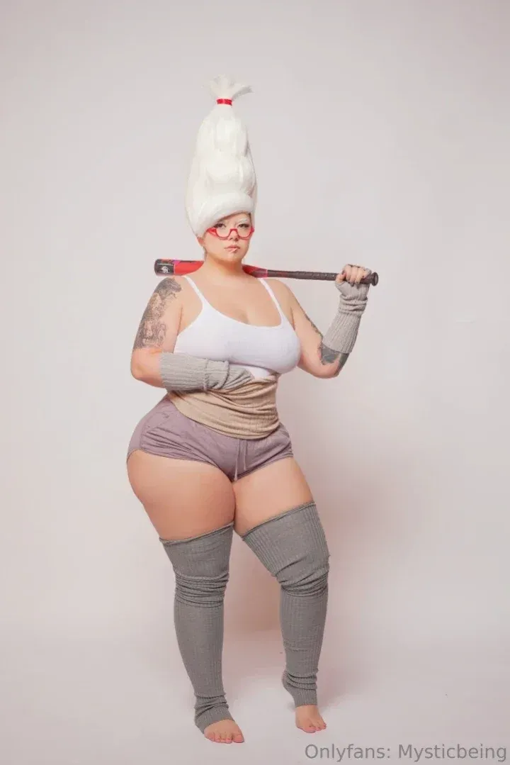 MysticBeing in a white wig and grey outfit holding a bat across her shoulders