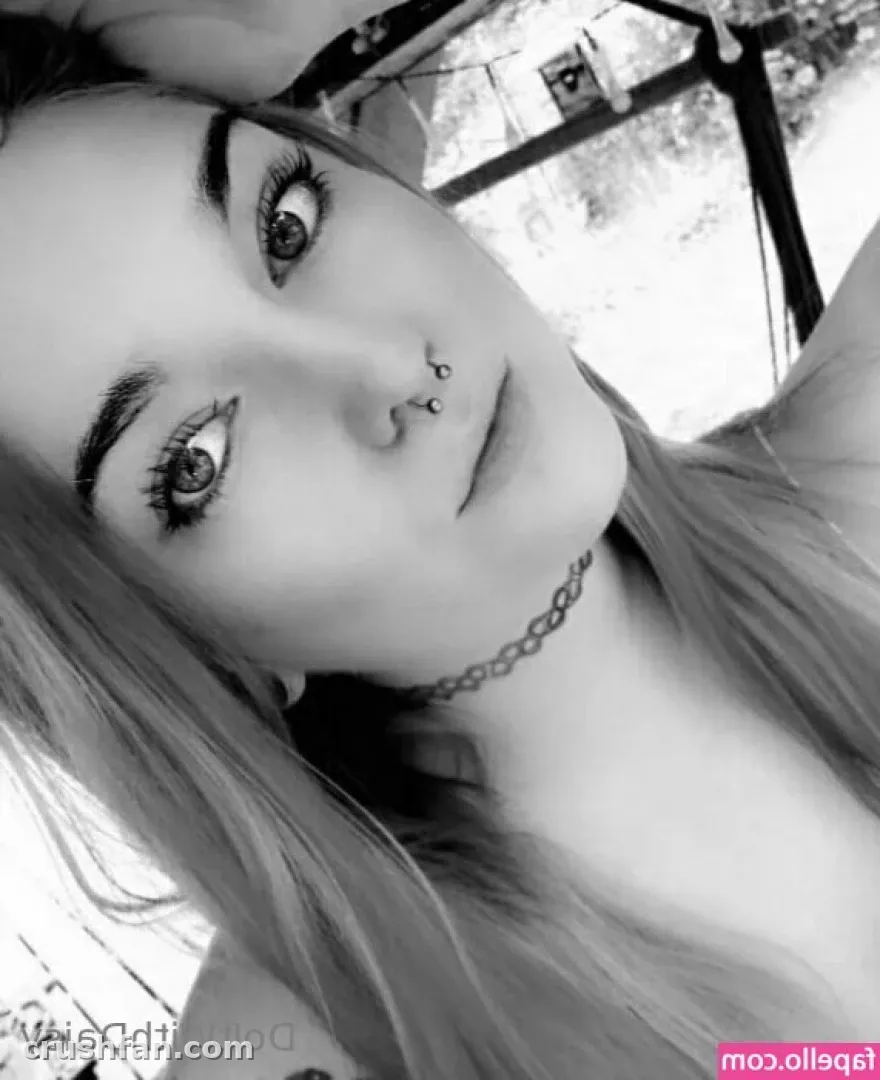 Black and white close-up portrait of DoItWithDaisy with a chain necklace
