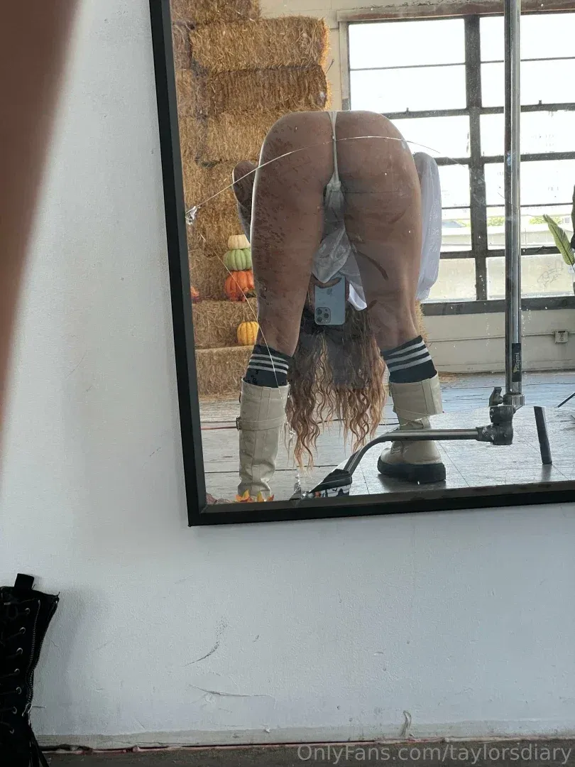 Taylor’s diary reflected in a mirror inside a rustic studio with hay bales and pumpkins