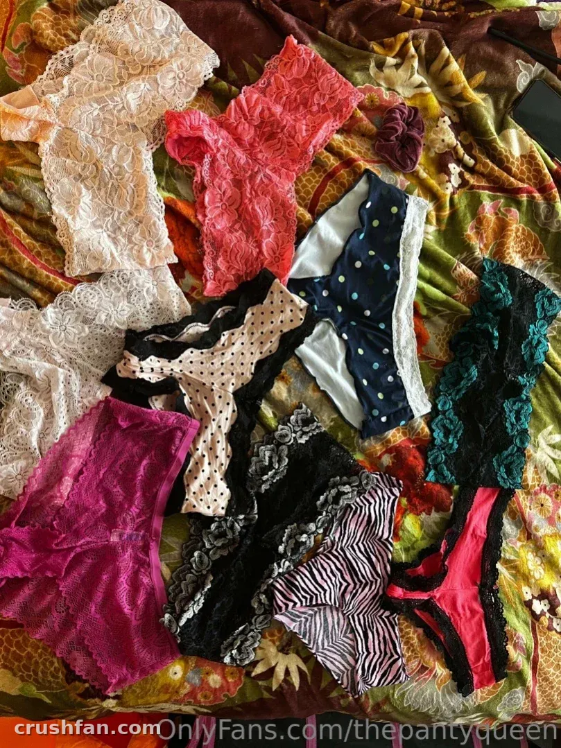 Assorted lace and patterned underwear arranged on a colourful patterned fabric