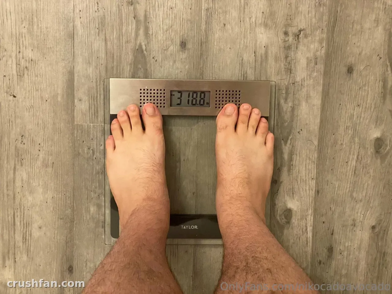 Bare feet standing on a silver digital scale on a light grey wood-look floor