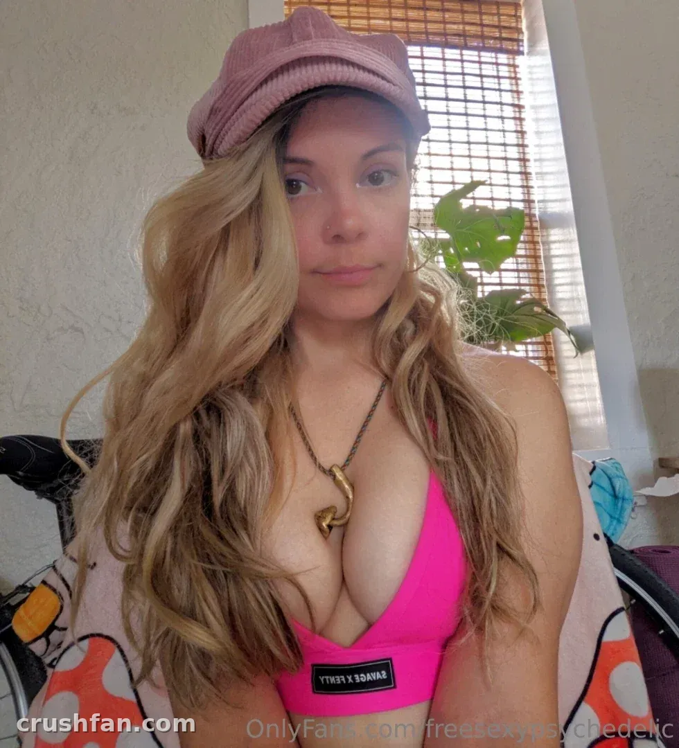Mycelia in a pink bikini top and rose cap indoors near a wooden blind