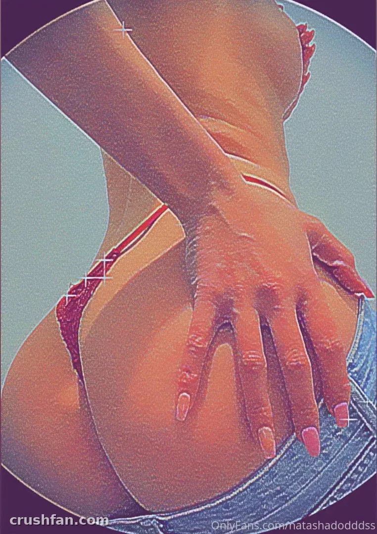 Natasha Dodds in a red bikini bottom and blue denim shorts, seen from behind