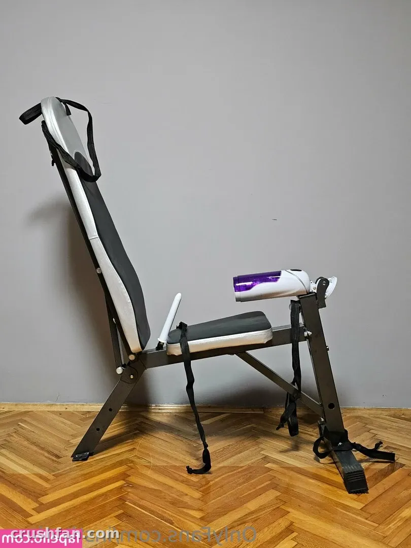 Folding workout bench with black frame and padded seat on a herringbone parquet floor