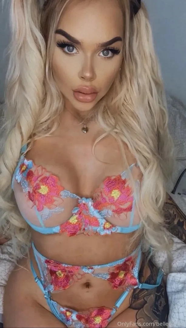 Creator in sheer floral lingerie with blue trim, blonde wavy hair, indoor portrait