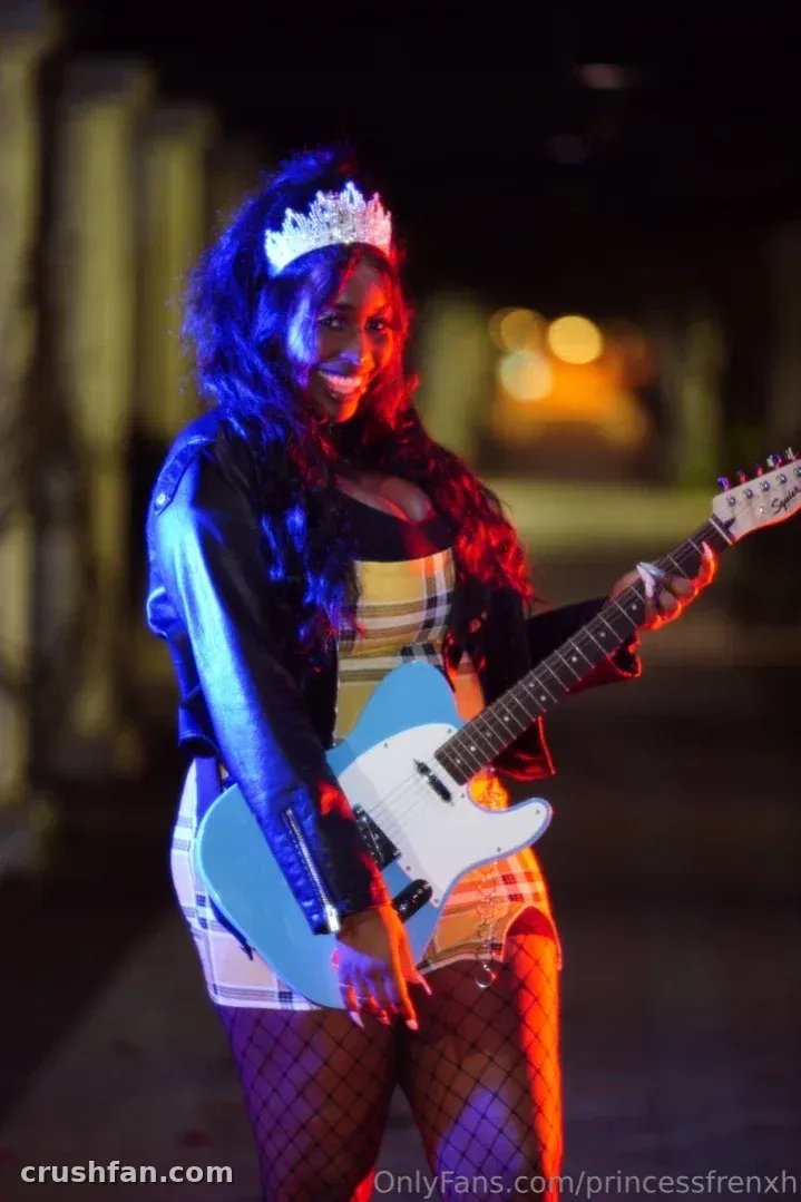 Princess Frenxh holding a blue electric guitar in colourful neon light