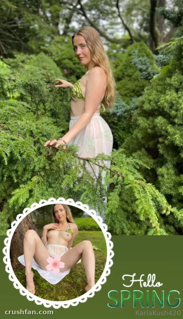 Creator in a green bikini top and white skirt standing among evergreen branches