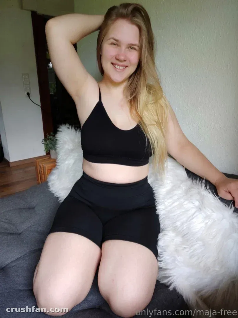 Maja-Meer in a black two-piece set seated against a white faux-fur throw indoors