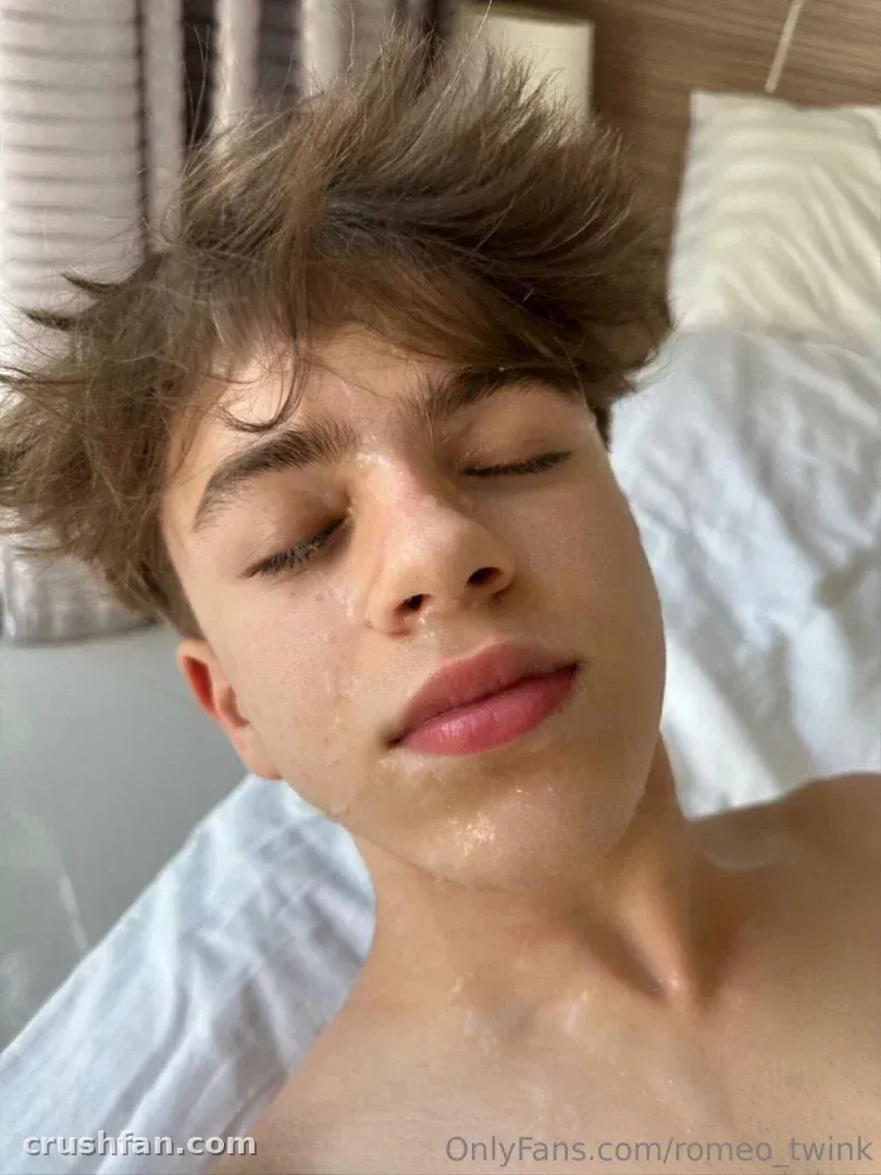 Romeo with eyes closed in a bright bedroom, bare-shouldered close-up portrait