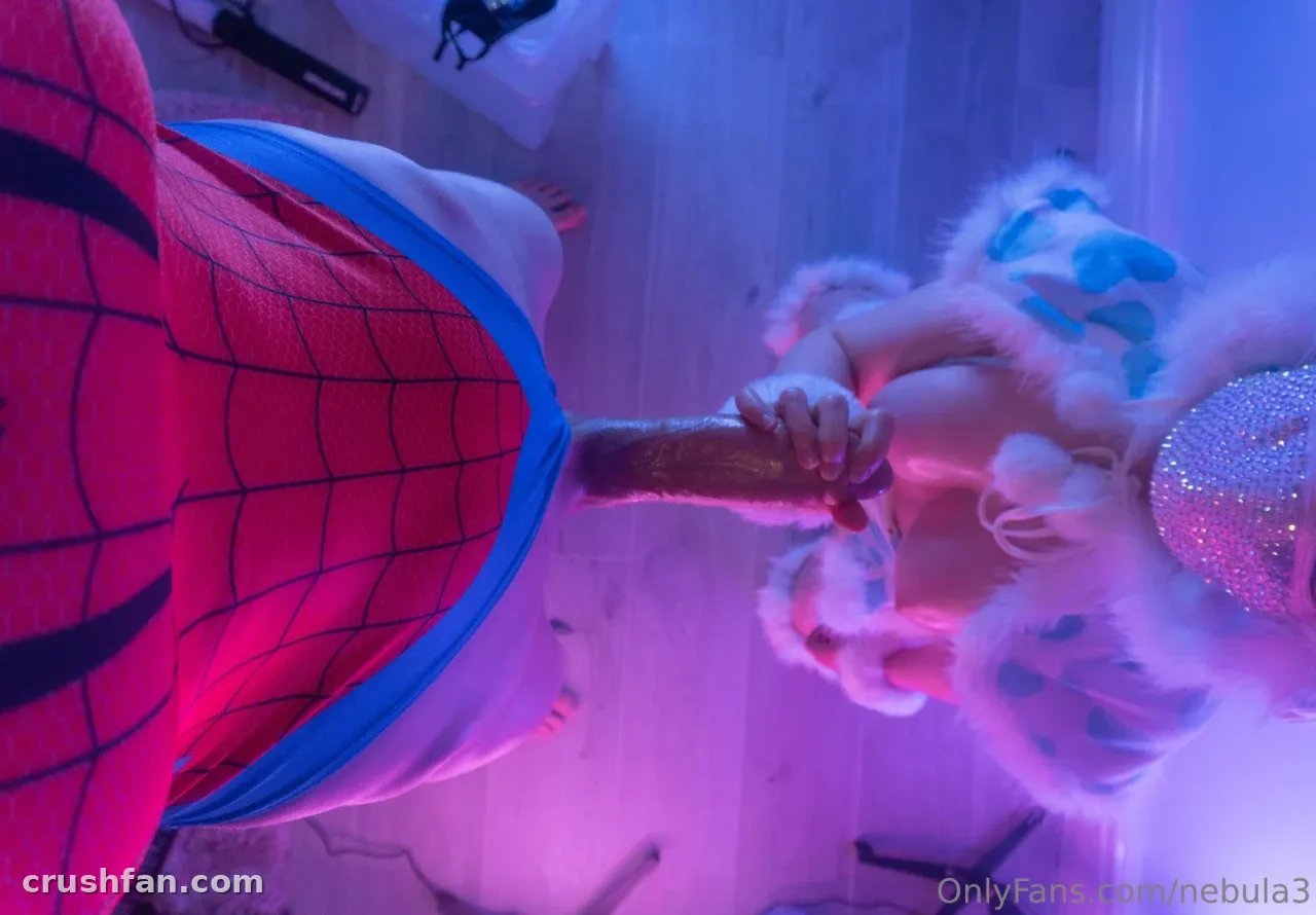 Nebula in a red and blue superhero bodysuit under pink and blue lighting