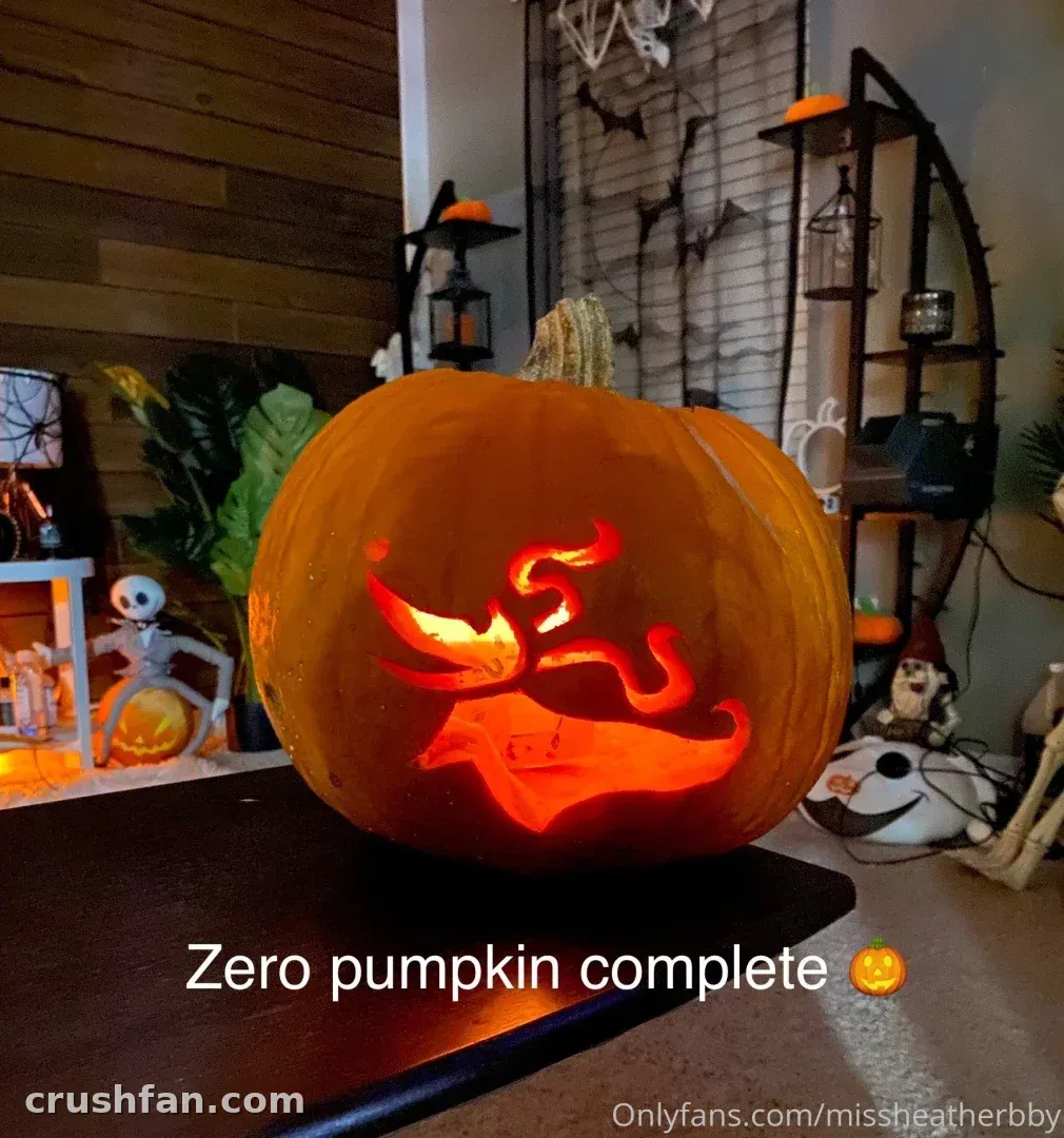 Glowing carved Zero-style pumpkin on a table surrounded by Halloween decorations
