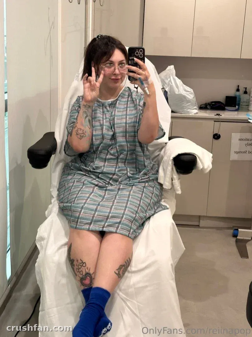 Reiinapop en blouse rayée et chaussettes bleues assise dans une chaise de clinique