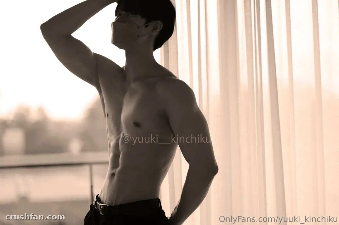 Yuuki stands shirtless in profile beside a sunlit window with sheer curtains