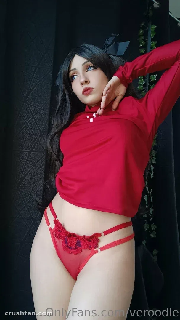 Veroodle in a red top and red lace bottoms posing against a dark studio background.