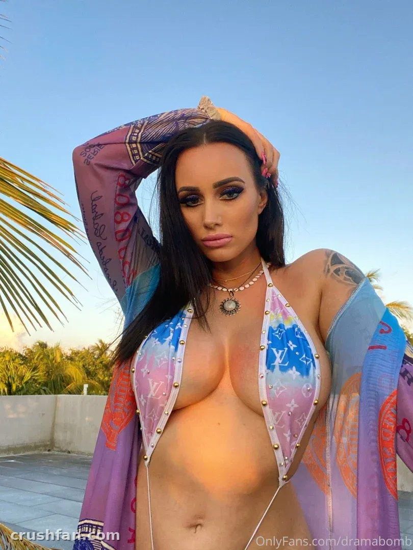 Creator in a floral halter top and sheer patterned wrap posing outdoors under a blue sky