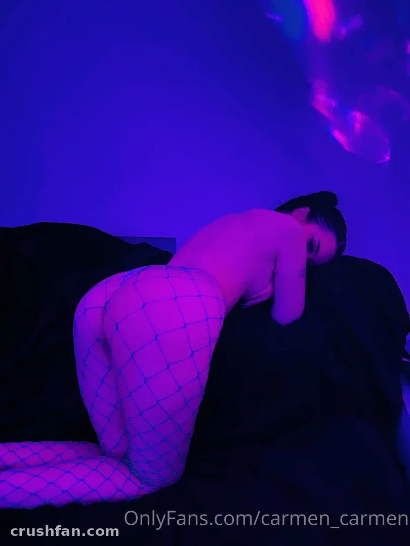 Carmenxcarmen in patterned tights under blue and violet lighting indoors