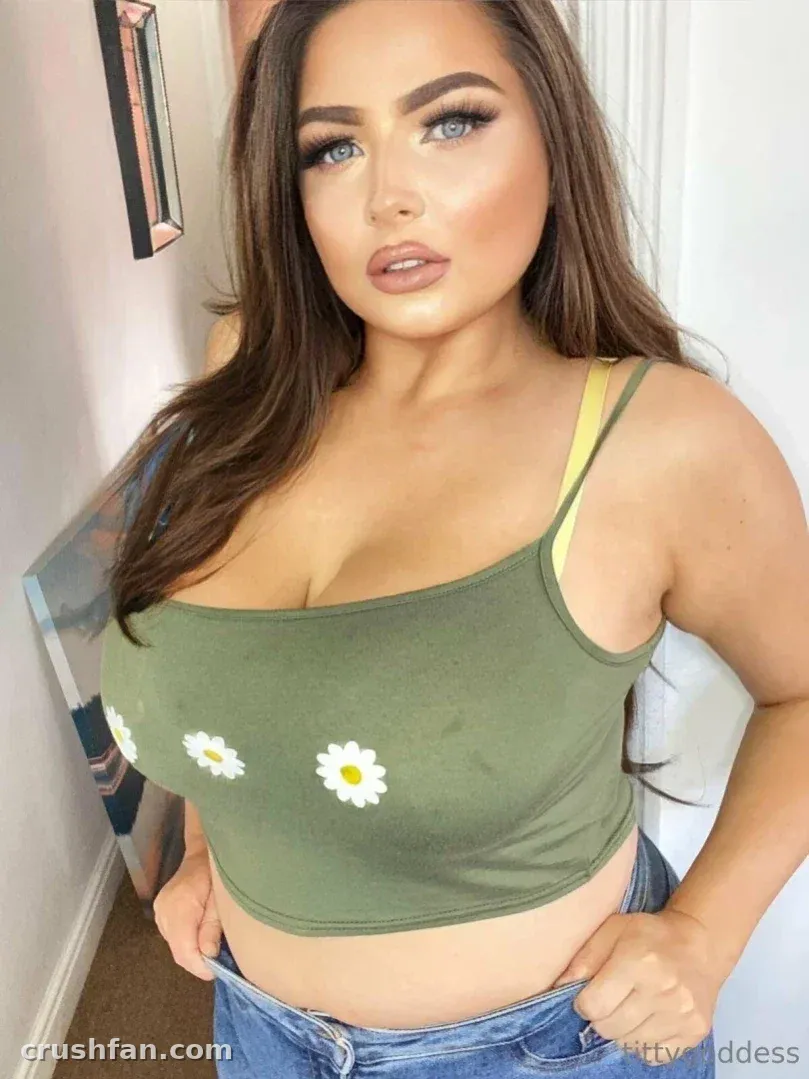 Mommy Milkers in a green daisy top and blue jeans indoors