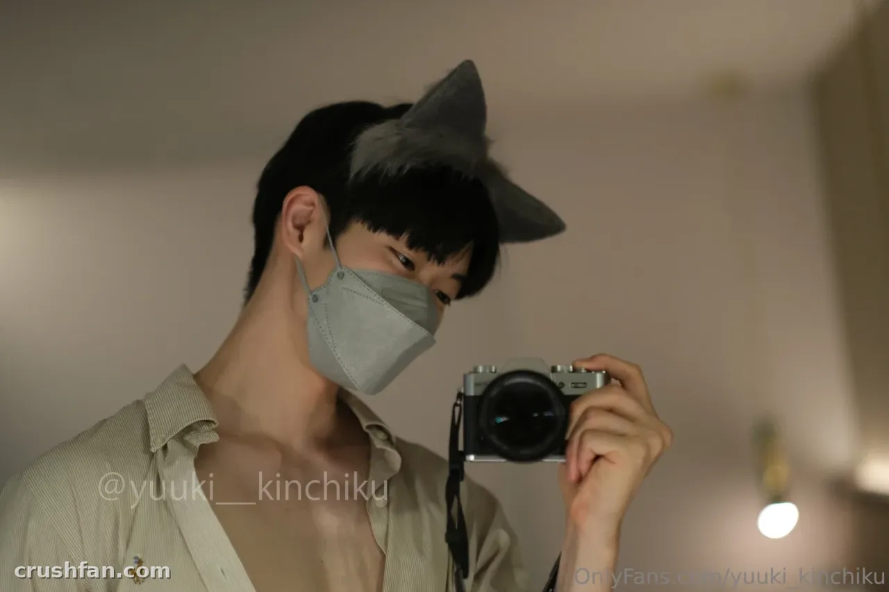 Yuuki in a face mask and animal ears holding a camera for a mirror selfie