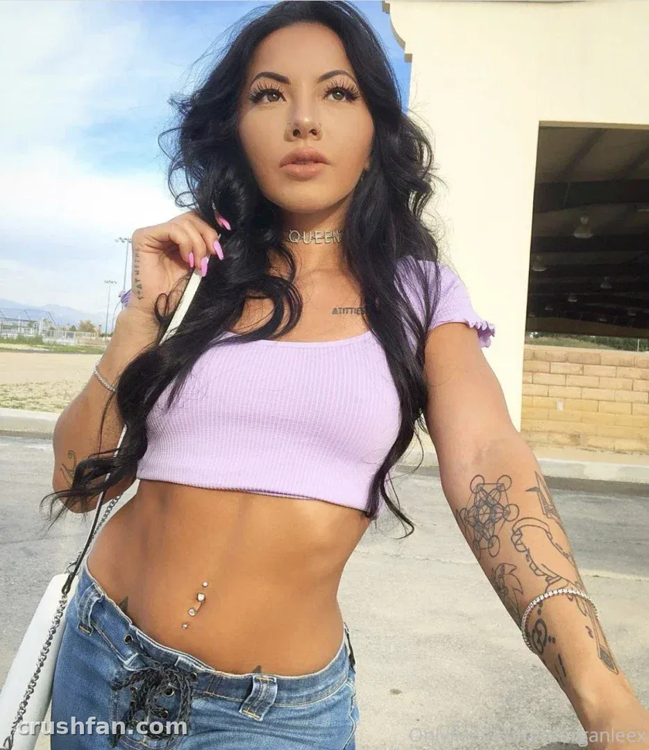 Lilkymchii in a lilac crop top and jeans posing outdoors in daylight