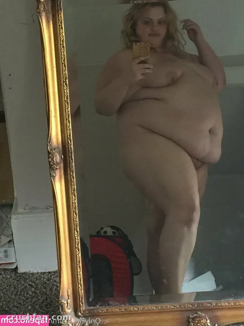 Sabrina poses nude in front of a gold-framed mirror for a selfie