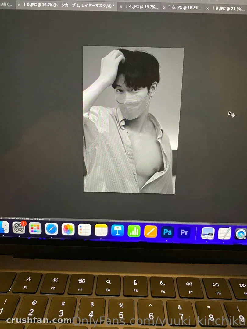 Black and white portrait on a laptop screen with editing software icons below