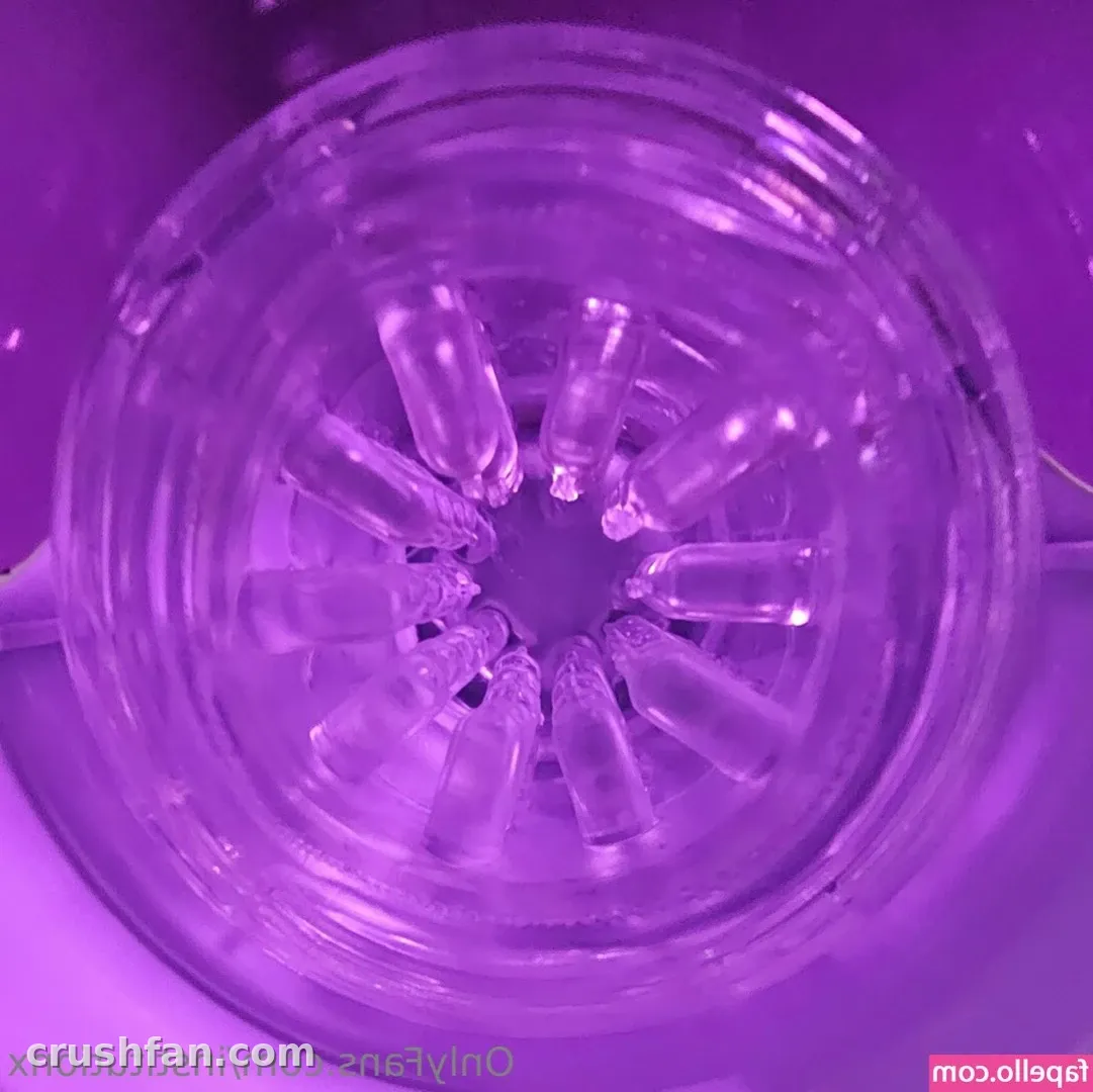 Close-up of a translucent purple-lit device with a radial pattern of soft segments