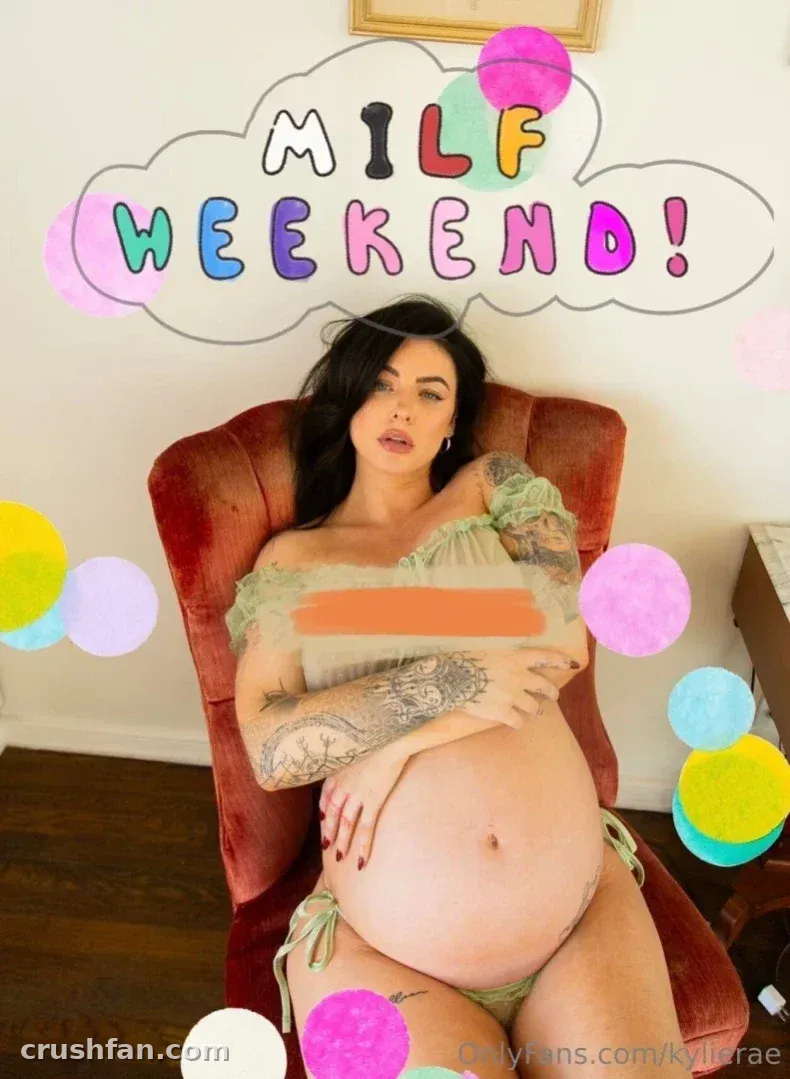 Kylie Rae sitting in a red velvet chair wearing a green off-shoulder top and matching bottoms.