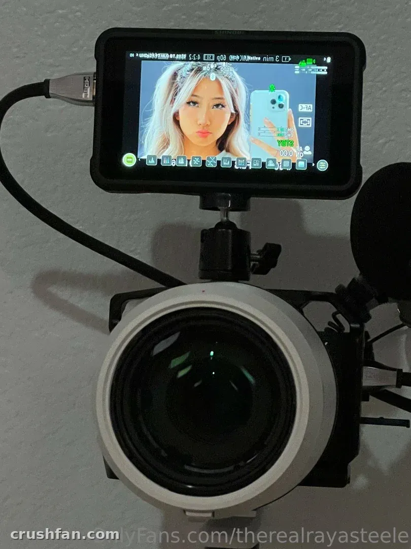 Aeries Steele shown on a camera monitor above a large lens in a studio setup