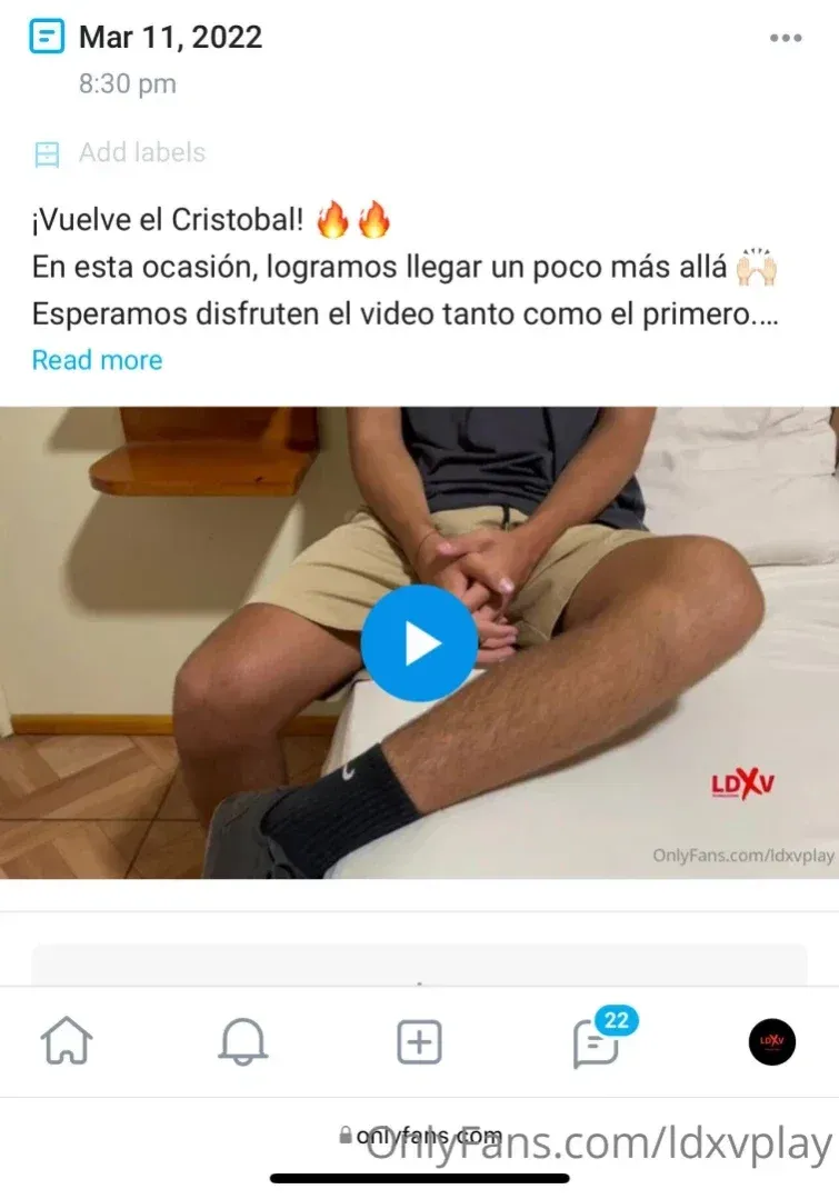 Creador sentado en una cama con ropa casual dentro de una habitación sencilla