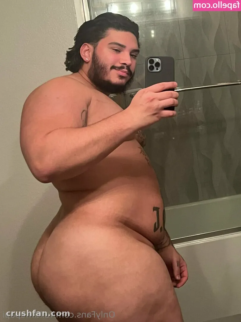 Diego Grant taking a side-on mirror selfie in a bathroom holding a dark phone