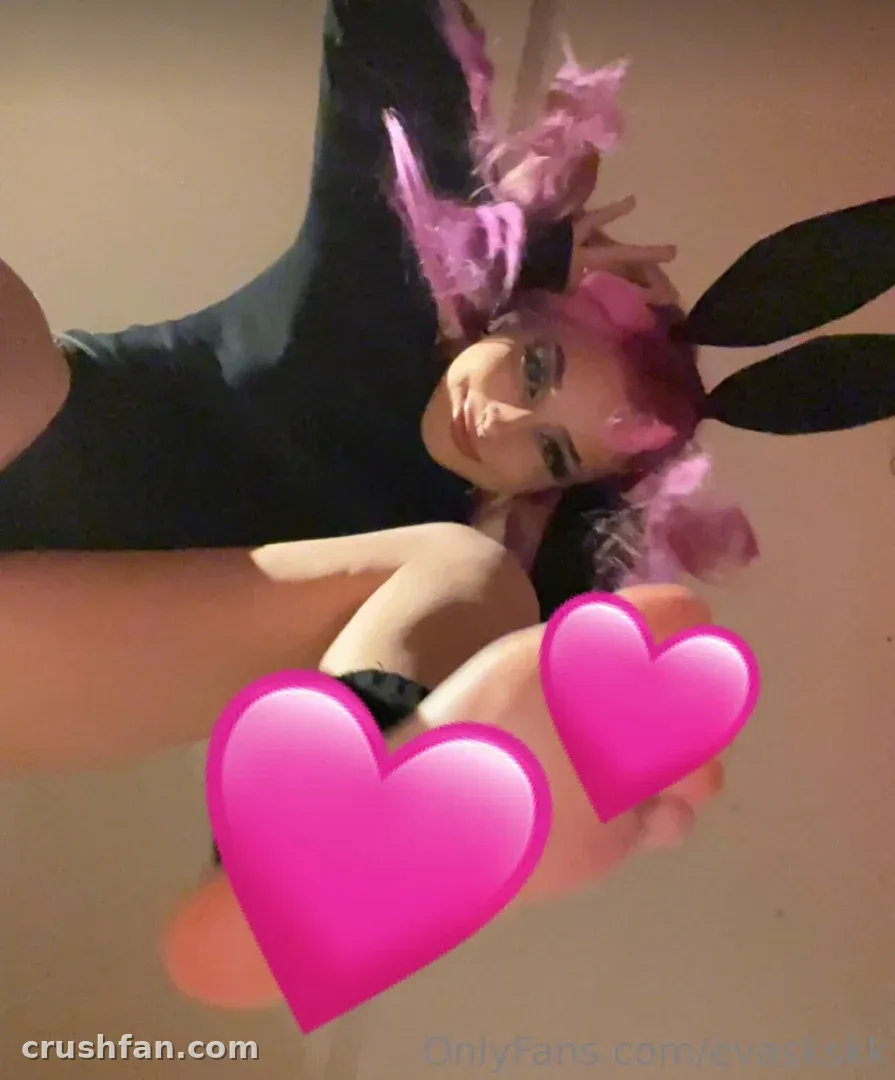 Eva Cappellini <3 in a pink wig and black bunny ears, with pink heart stickers in front.