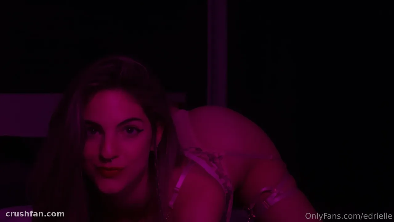 Edrielle posing indoors under deep magenta lighting