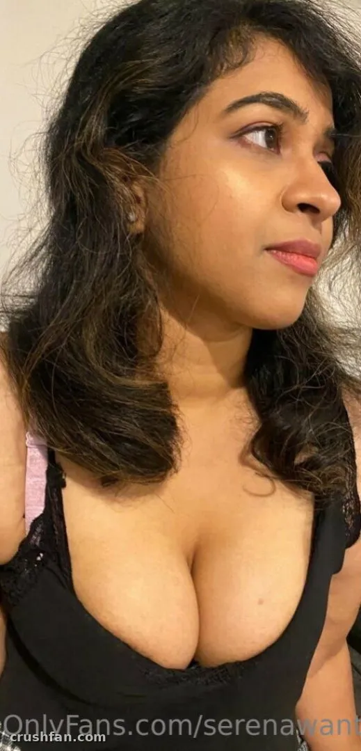 Serena in a black top looking off camera indoors