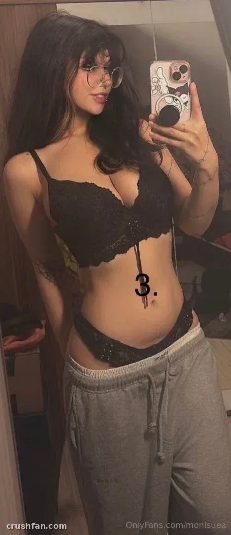 Monii♡ taking a mirror selfie in black lace lingerie and grey sweatpants.