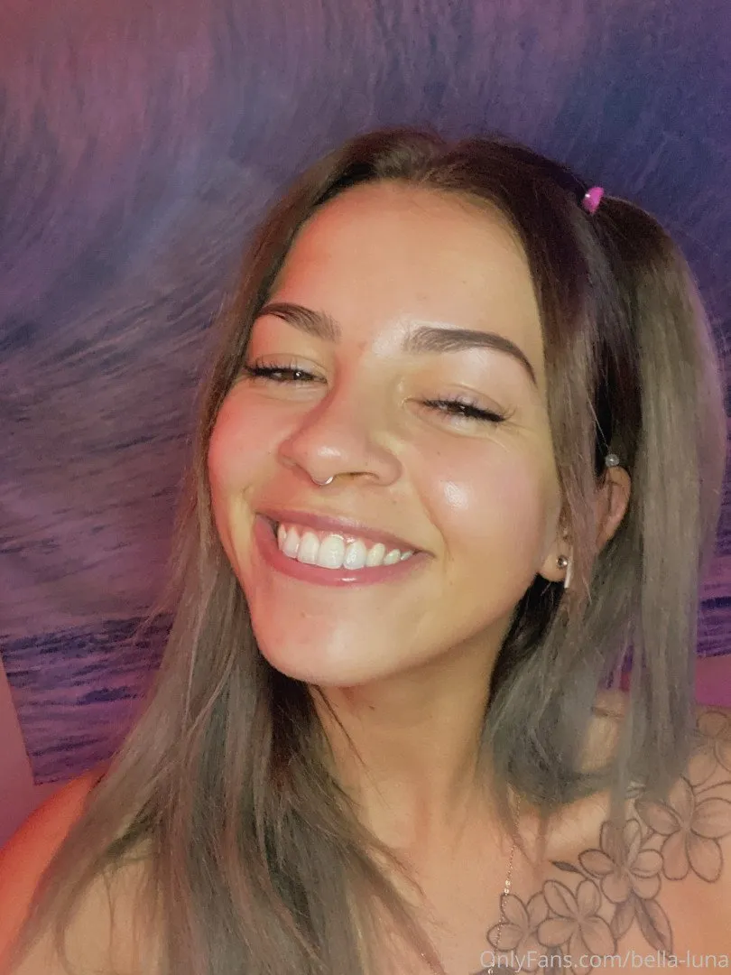 Retrato en primer plano de Bella Luna sonriendo contra un fondo morado texturizado