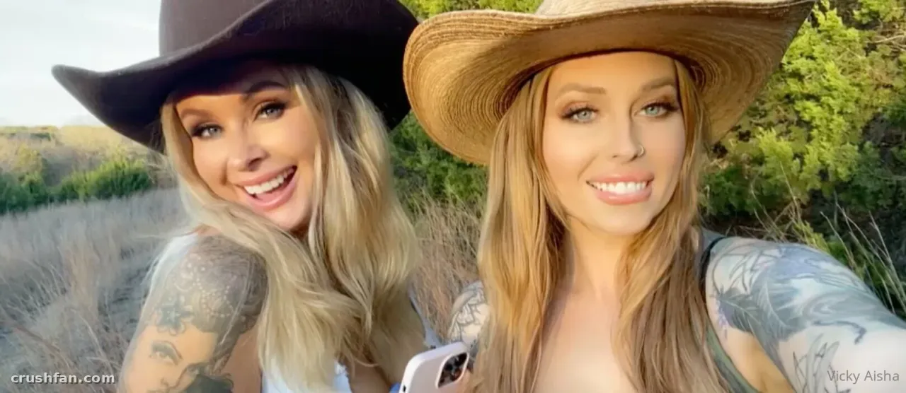 Vicky Aisha smiling outdoors in a wide-brimmed hat with tattoos visible