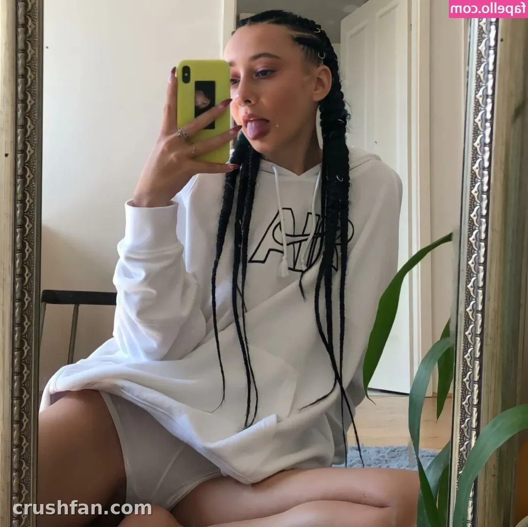 𝐋𝐢𝐥𝐚 in an oversized white hoodie taking a mirror selfie with a green phone