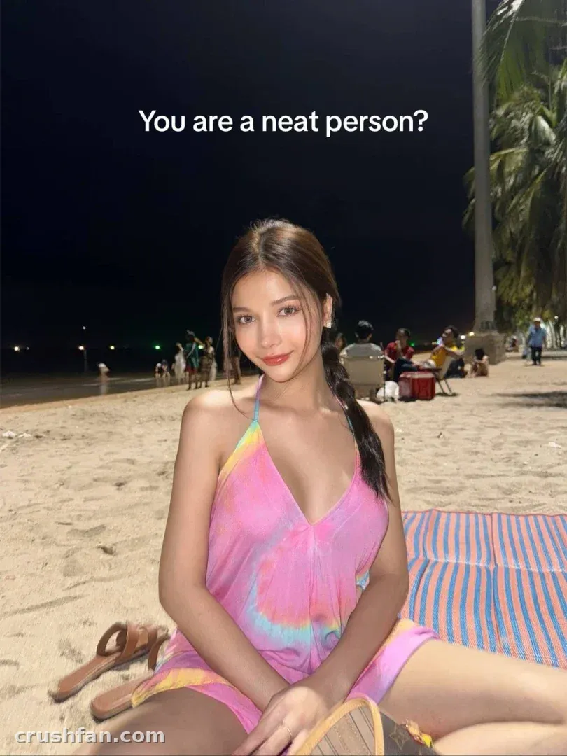 ZugusHotxx in a colourful halter cover-up sitting on a night beach