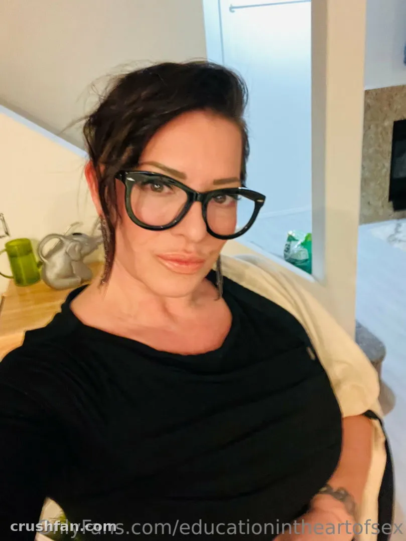 BC Madison Gulli wearing glasses and a black top in a bright indoor selfie.