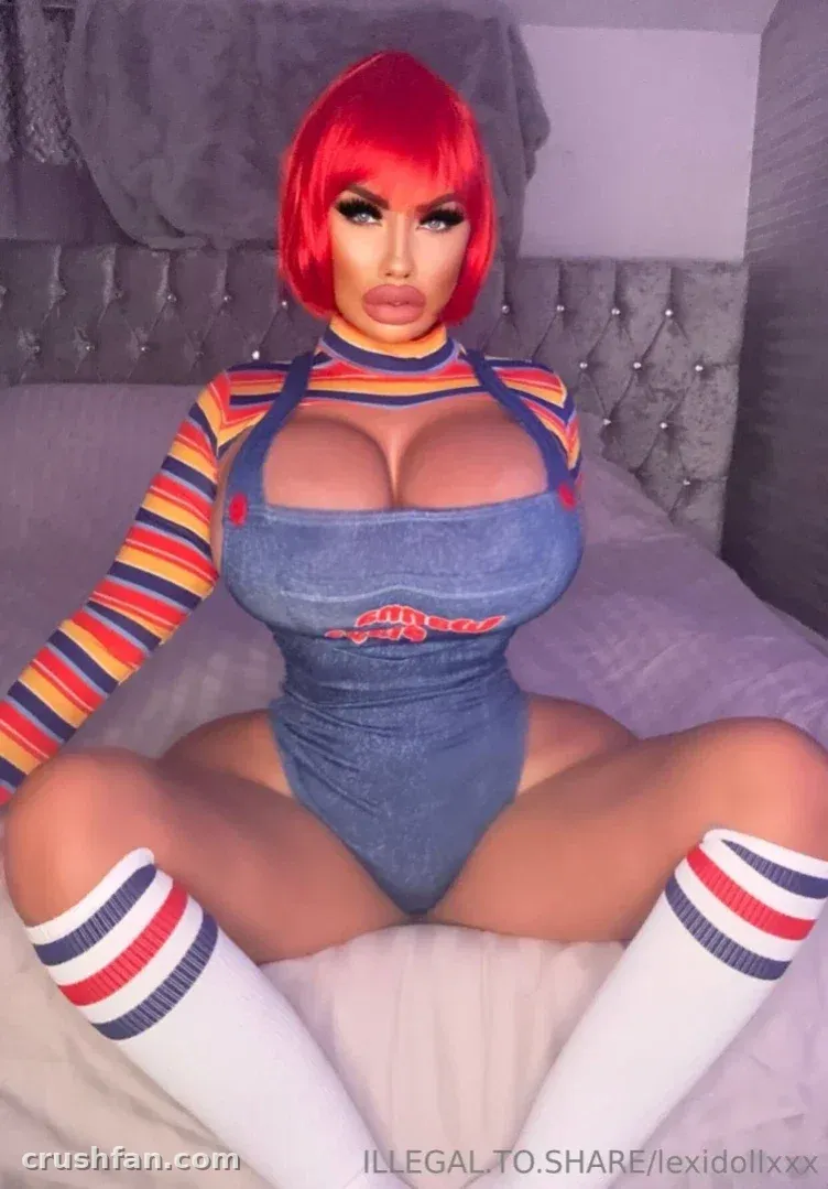 Lexi avec un haut rayé et un body en jean assise sur un lit gris