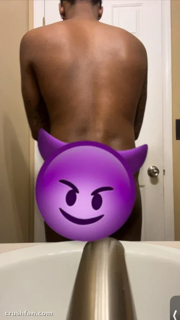 Creator standing at a bathroom sink with a large purple devil emoji covering the lower frame.