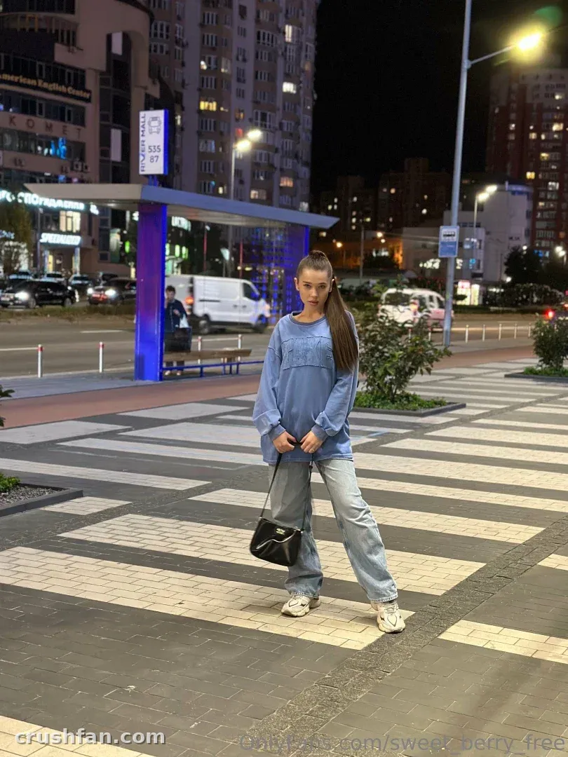 Sweet Berry in blue denim on a night city crossing